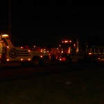 squires towing a tractor trailer at night